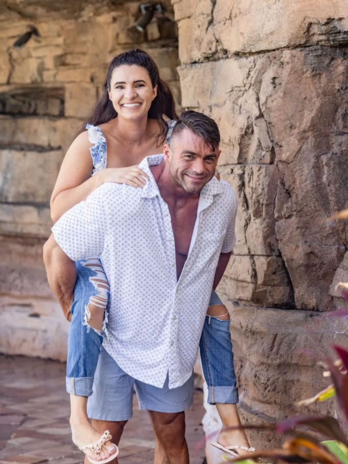 Bodybuilder Jason Lowe carrying his wife on his back