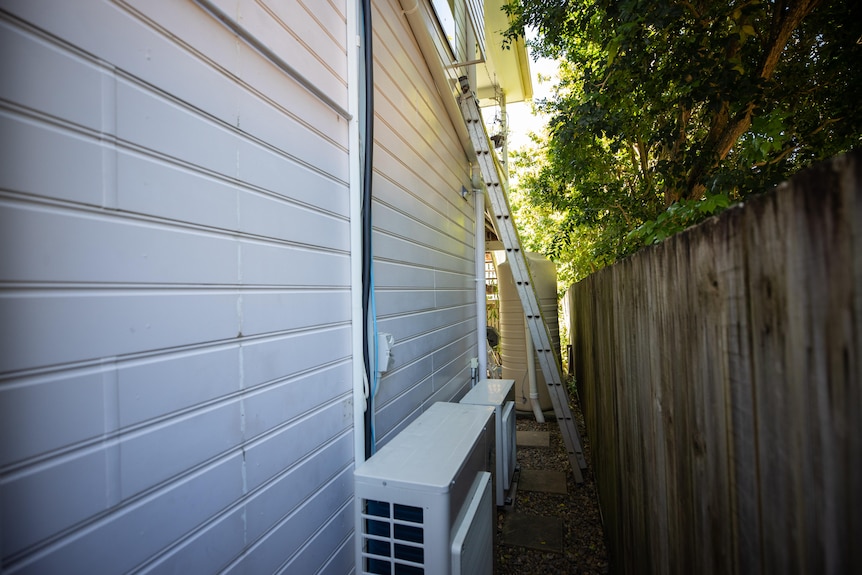 A photo of a ladder leaning against a house