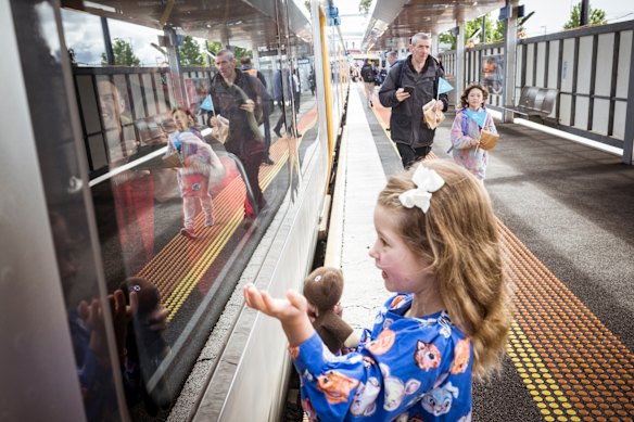 An excited young passenger at Sunbury station waves at those on the first service towards the Metro Tunnel in November.