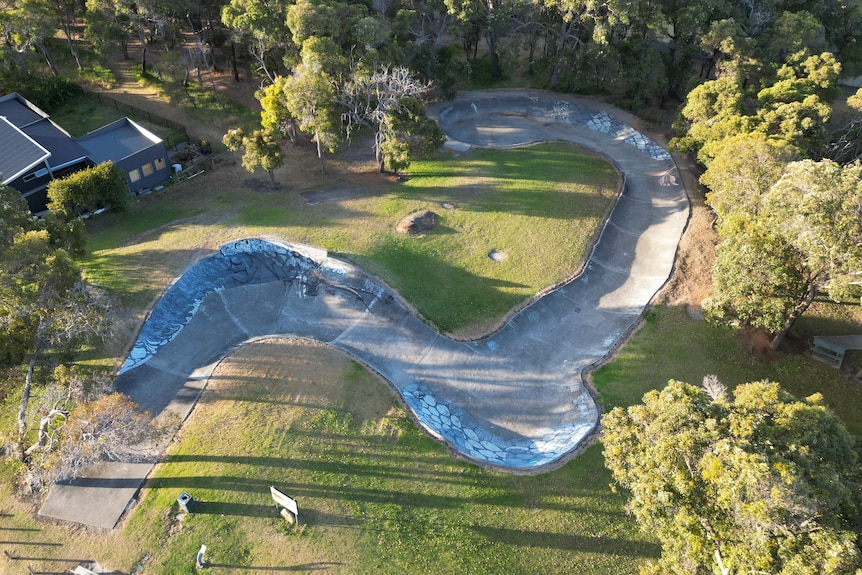 A winding downhill concrete strip.
