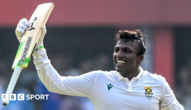 Senuran Muthusamy raises his bat after scoring a century for South Africa
