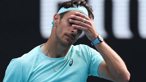 Lorenzo Musetti reacts after retiring from his quarter-final against Novak Djokovic.