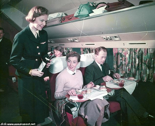 In the 1950s to the 1970s, dress codes were strictly formal, with men in suits and women in cocktail dresses or heels. Pictured: Vintage photos show Scandinavian Airline passengers being served lobster, caviar and cream cakes during the golden age of flying