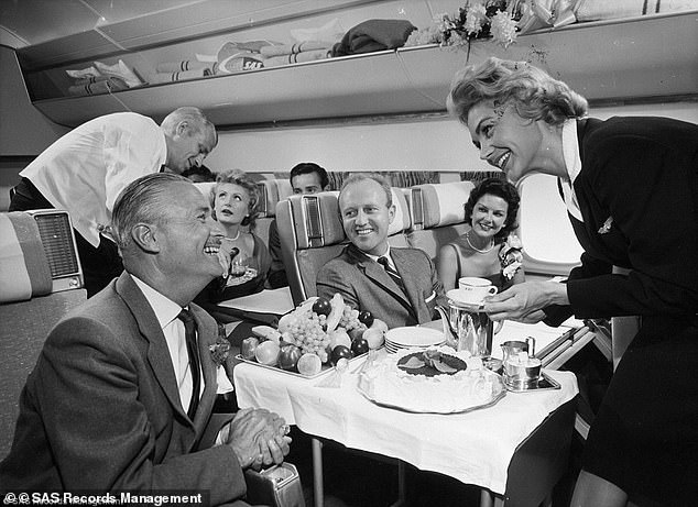 Caviar, sir? During the 'golden age' of flying - in the 1950s and 1960s, first class passengers could expect hand-carved roasts at 30,000ft...and the chance to enjoy a cigarette and a drink in the cocktail bar afterwards. Pictured: passengers onboard a Scandinavian Airlines flight in he 1950s