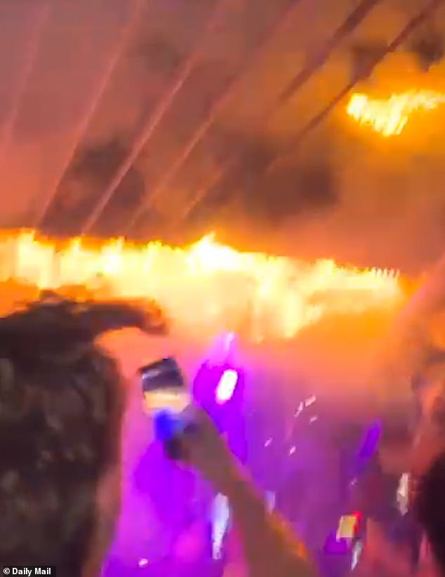 In video footage someone can be seen trying desperately to extinguish the fire, but within seconds it takes hold, erupting into a deadly fireball that engulfs the packed bar