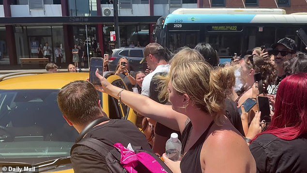 Hours waiting in the sun during Sydney's heatwave that saw the mercury rise to 33 degrees Celsius only added to the hysteria, with the flustered rocker making a getaway in a waiting car