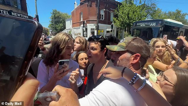 Police were forced to disperse crowds attending an exhibition in Sydney on Thursday after a visiting rock star was mobbed by hundreds of fans