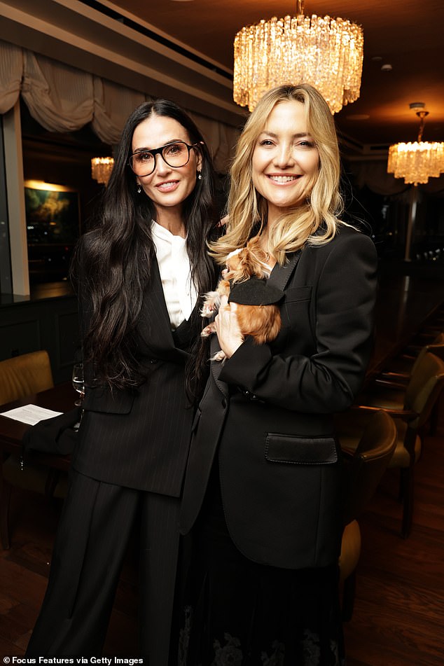 Hudson wore a black blazer as she held on to Moore's dog Pilaf