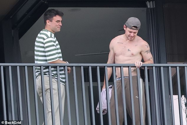 A shirtless and smiling Neale was joined for a two-hour visit by a buddy who works for Nova