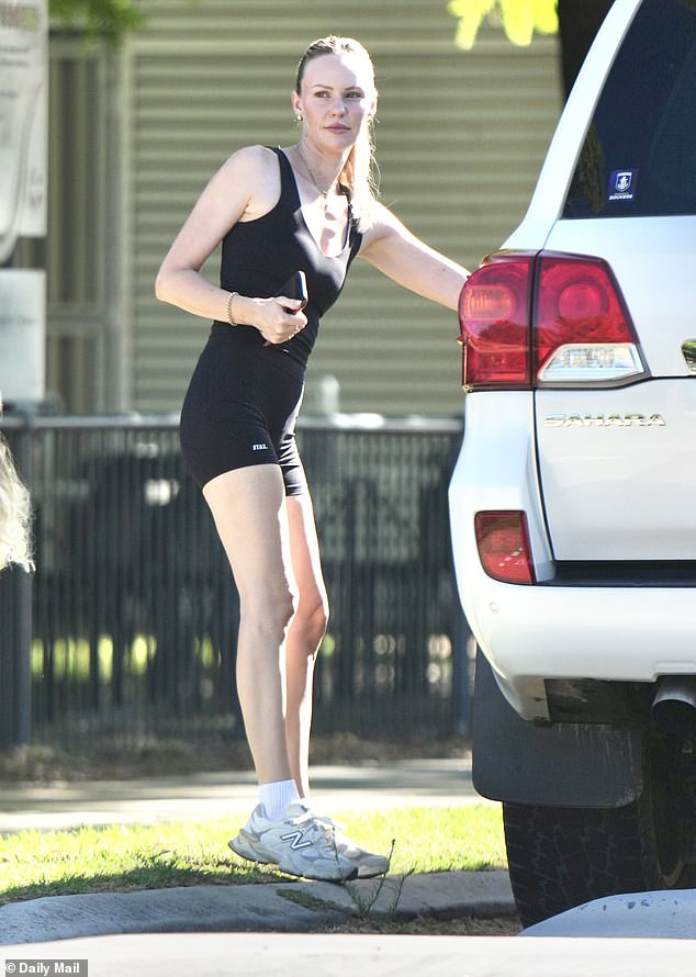 Jules dressed casually for the occasion, sporting a plunging black top and matching bike shorts