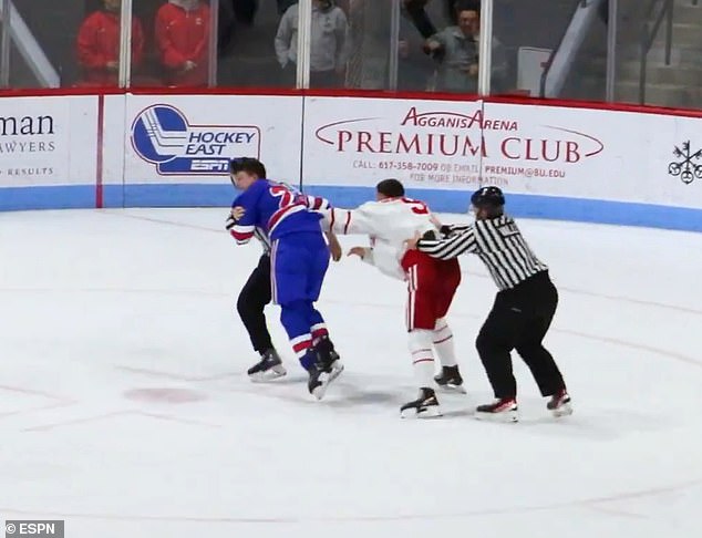 Eddy (in blue) was spun around by a vicious punch to the temple from BU's Boisvert