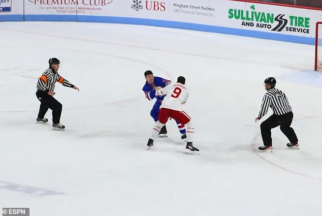 Officials rush in to break up the rare college hockey fight during Friday's game in Boston