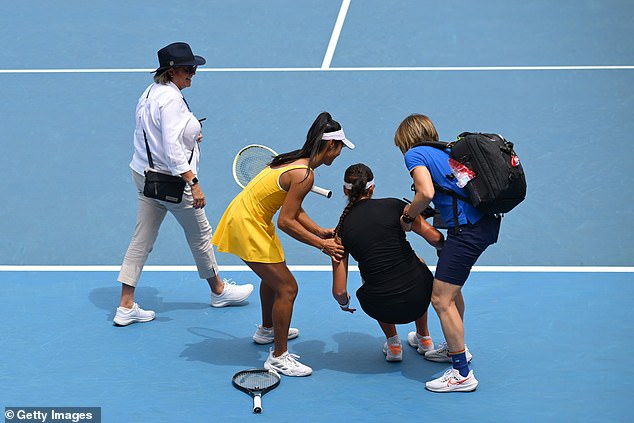 Hon rushed to her opponent's aid, helping her to her feet before Stakusic (second from right) was taken from the court in a wheelchair