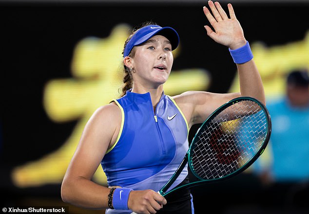 Mirra Andreeva is pictured saluting the crowd at the Australian Open on Wednesday night. Many fans believe she told spectators 'f*** you all', while others are adamant she said 'thank you all'