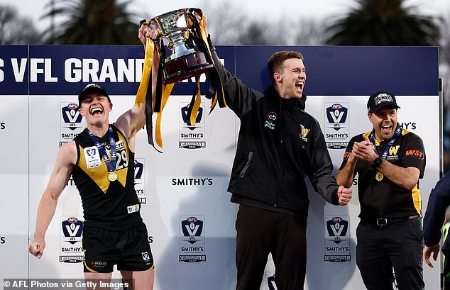Dom Brew, Nick Coughlan and Jimmy Allan are pictured celebrating after winning the 2024 VFL Grand Final
