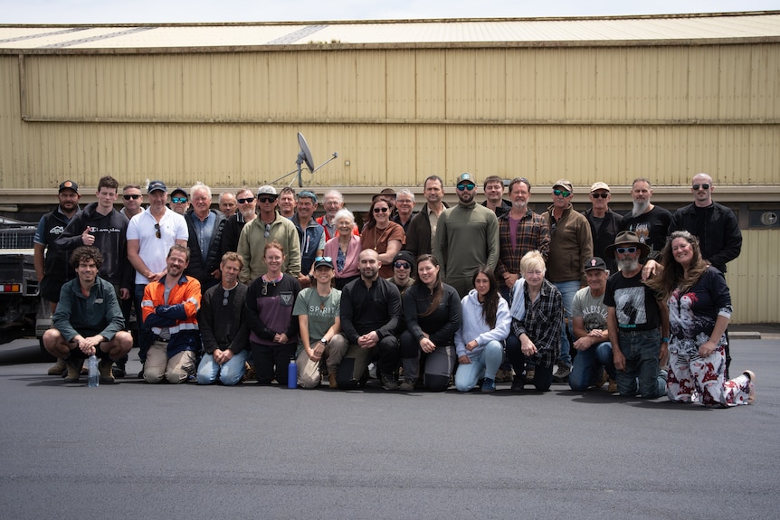 Group of roughly 40 people stand for photo.