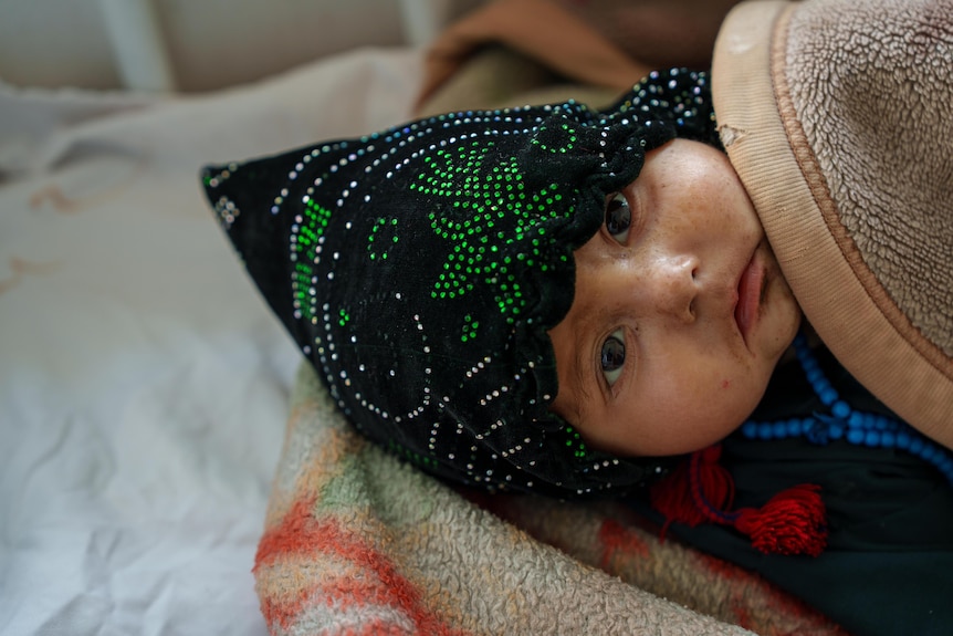A baby in a cot in Afghanistan.