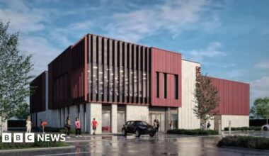 A drawing of a large building with a pale lower level and a brick-red upper level and tall, vertical windows, with a car park in front