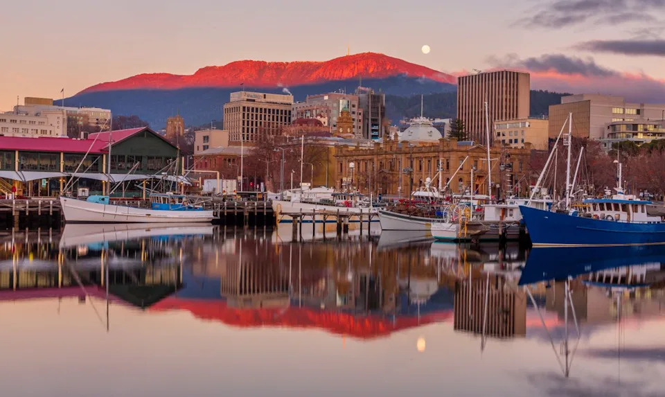 Steve Daggar Photography / Getty Images Hobart's Constitution Dock at sunrise. The Tasmanian capital offers retirees waterfront living, mild weather, and home prices roughly 45% below Sydney.