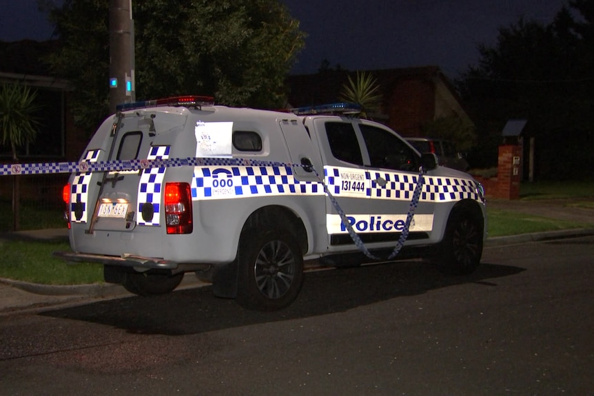 A police vehicle parked in a street at night.