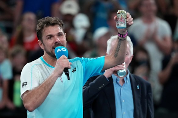 Retiring Swiss star Stan Wawrinka raises a beer to the crowd after his last Australian Open match. 