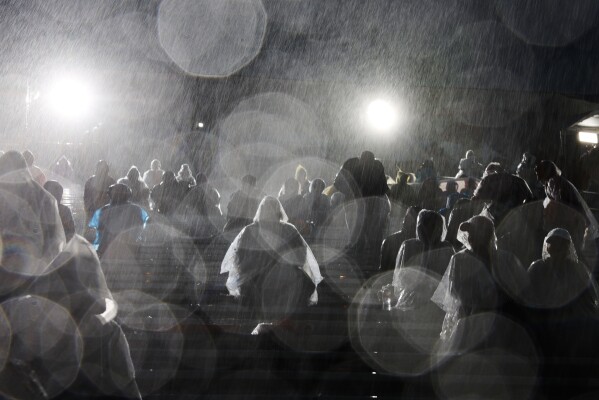 Rain comes down on attendees at the 137th Rose Parade Thursday, Jan. 1, 2026, in Pasadena, Calif. (AP Photo/Caroline Brehman, File)