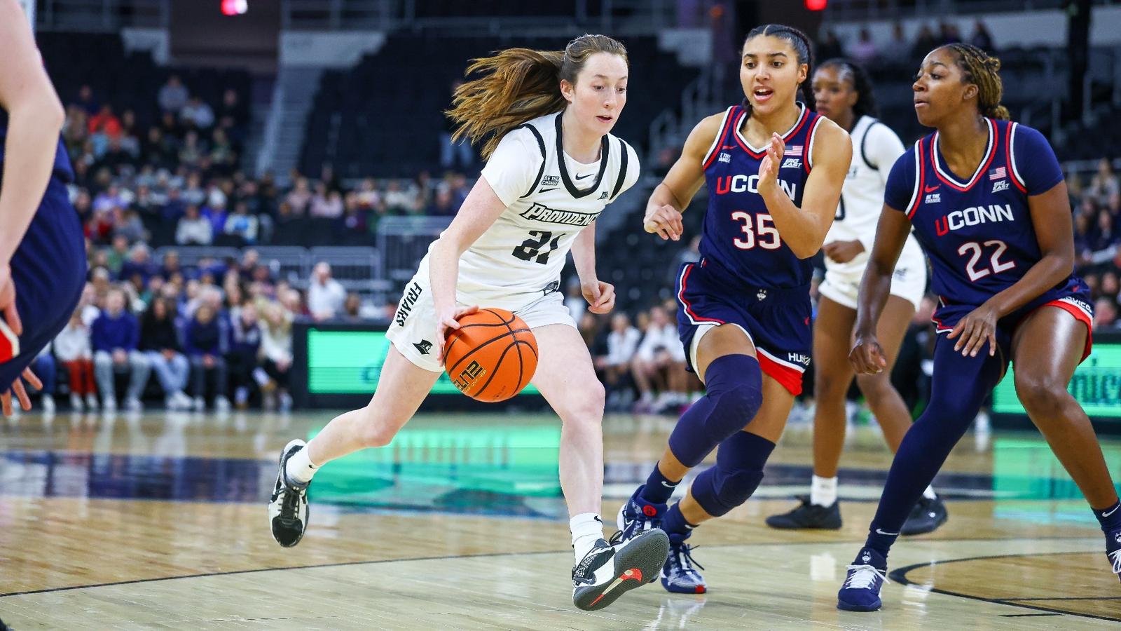 Orlagh Gormley dribbling the ball with a defender on her at the AMP during a conference game against UConn.