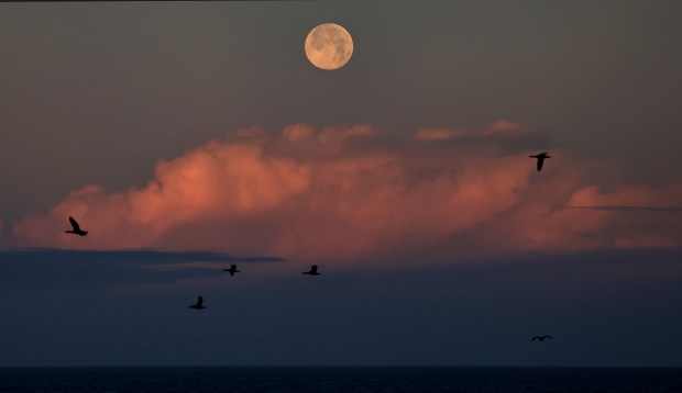 The Wolf Moon sets over a building thunderstorm, Saturday, Jan. 3, 2026, photographed north of Bodega Bay. (Kent Porter / The Press Democrat)