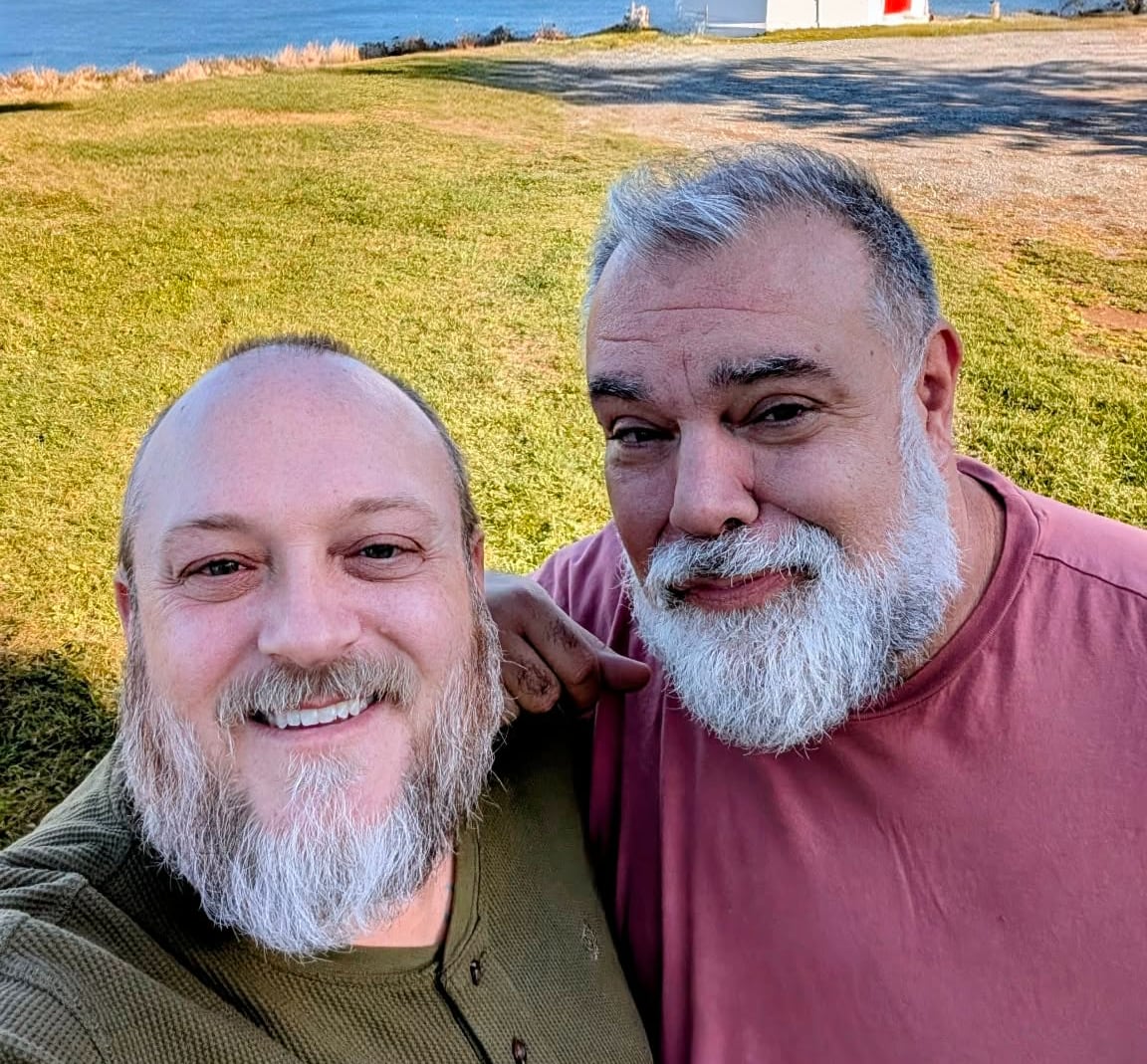 Two men pose together for a photo.