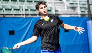 Duke men's tennis signee Jakub Smejcky takes a backhanded swing at a tennis ball while playing on a purple court.