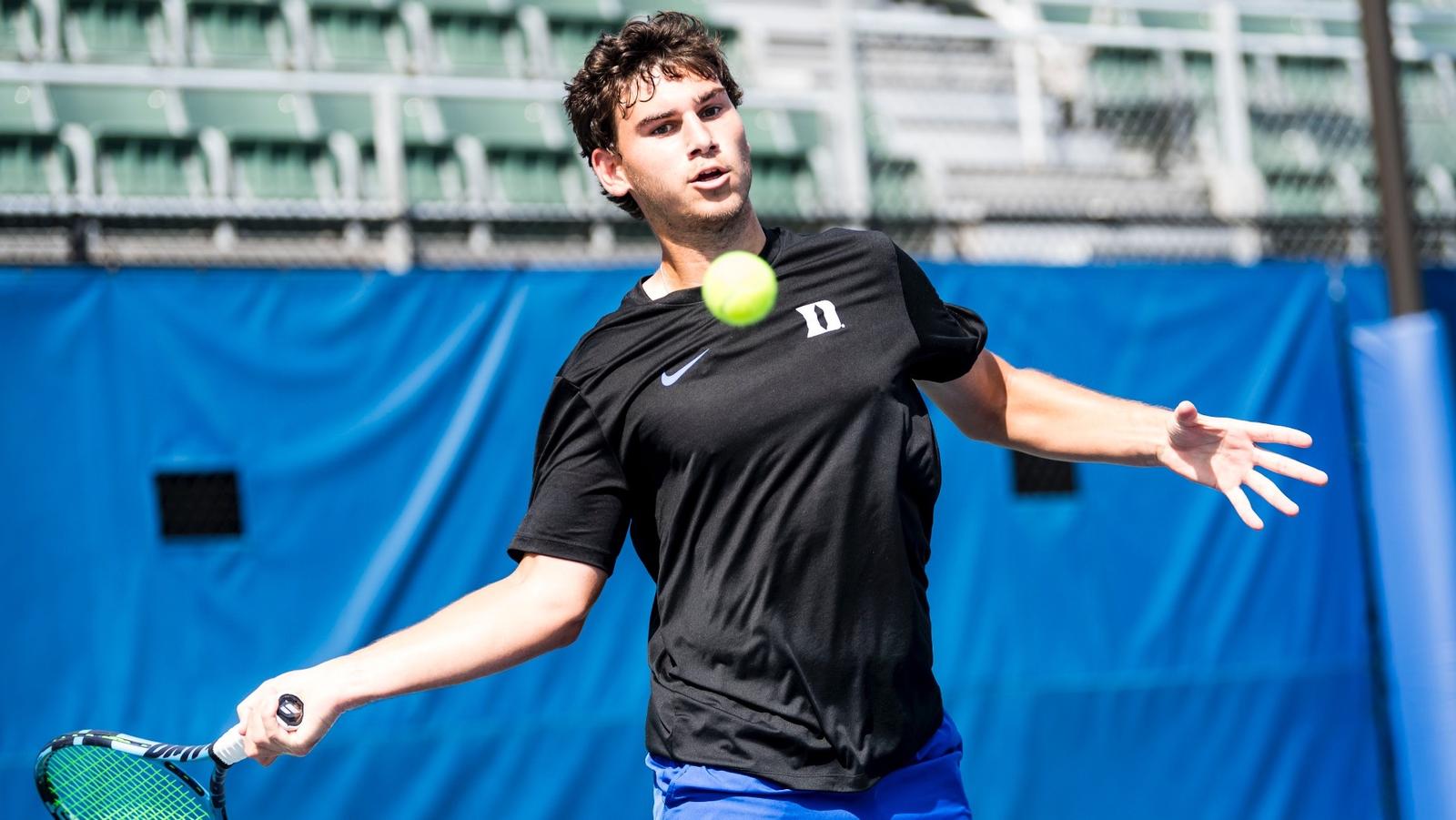 Duke men's tennis signee Jakub Smejcky takes a backhanded swing at a tennis ball while playing on a purple court.
