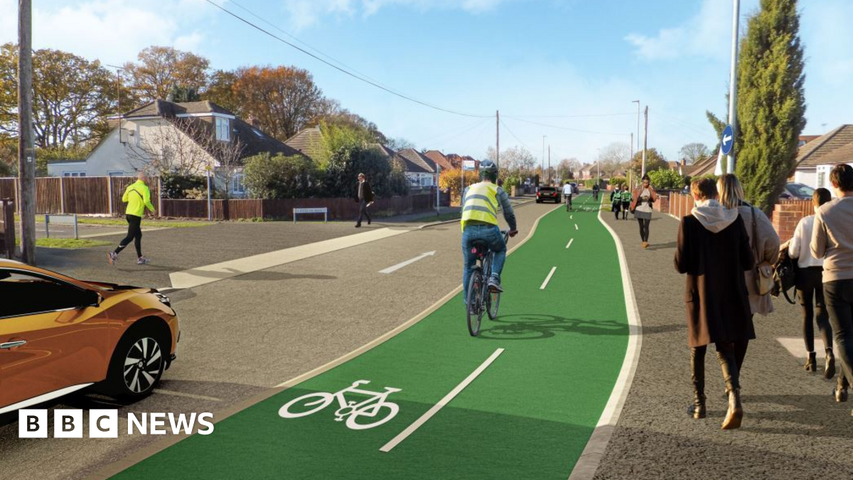 A CGI image of Woodlands Avenue, with cyclists using a distinctive marked green cycle path which is divided into two paths, a runner on a pavement opposite and people walking on a pavement closer. An orange car is driving just behind the cyclist.