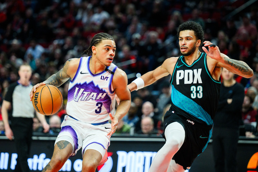 Utah Jazz guard Keyonte George (3) drives towards the basket past Portland Trail Blazers forward Toumani Camara (33) during the second half of an NBA basketball game, Monday, Jan. 5, 2026, in Portland, Ore. (AP Photo/Molly J. Smith)