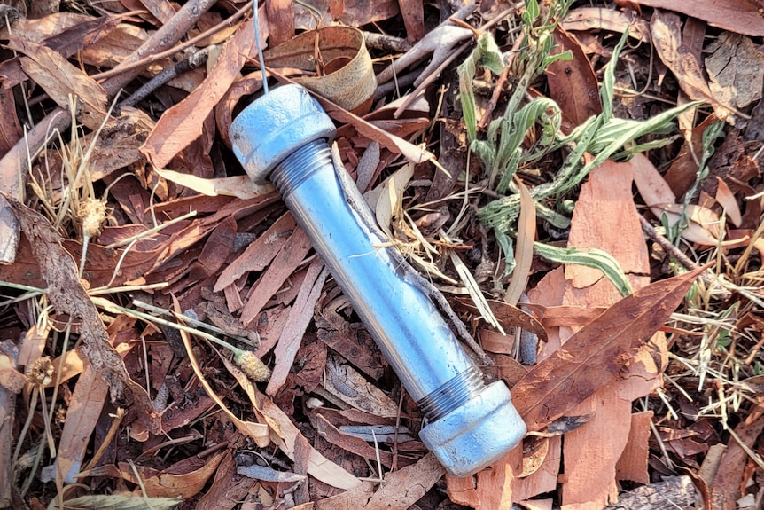 A pipe bomb outside on the ground