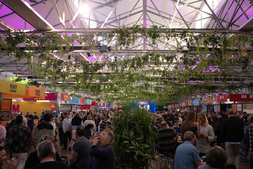 People gathering at a big colourful music and food festival.