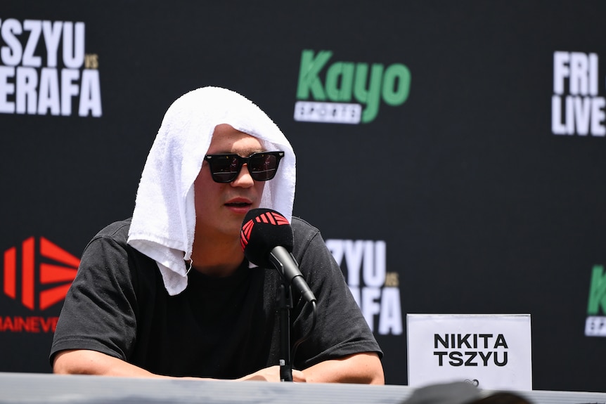 Nikita Tszyu sits with a towel on his head