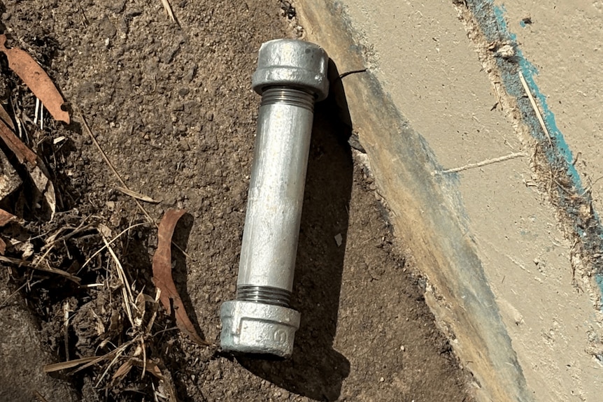 A close up of a silver pipe bomb