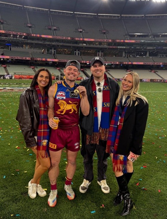 Lachie Neale and Jules Neale with Ben Crosley and Tess Crosley after Brisbane's 2025 grand final win.