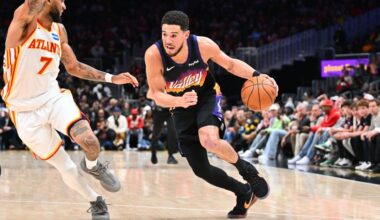 Suns' Devin Booker exits loss to Hawks after rolling right ankle