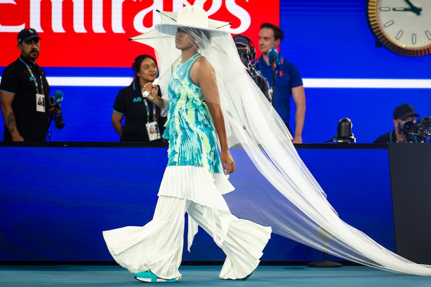 Naoi Osaka walks onto Rod Laver Arena at the Australian Open.