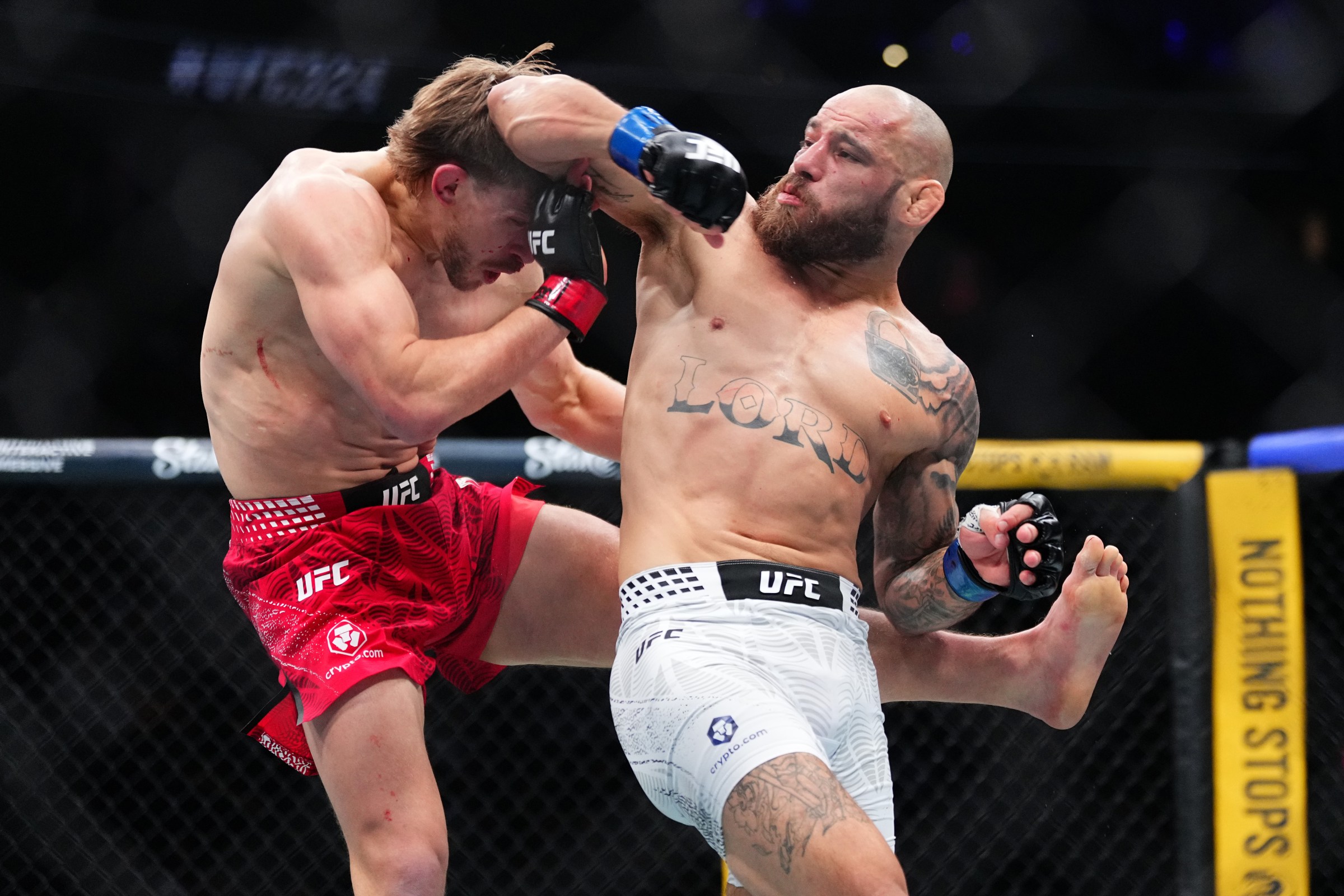LAS VEGAS, NEVADA - JANUARY 24: (R-L) Jean Silva of Brazil strikes Arnold Allen of England in a featherweight bout during the UFC 324 event at T-Mobile Arena on January 24, 2026 in Las Vegas, Nevada. (Photo by Jeff Bottari/Zuffa LLC)