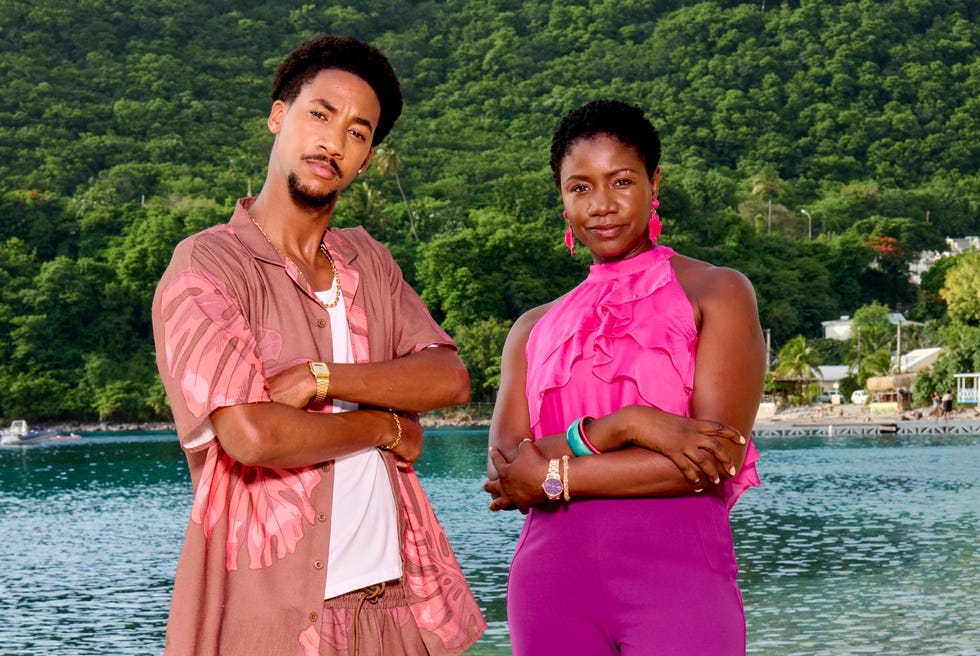 death in paradise shaquille ali yebuah and ginny holder as seb and darlene standing shoulder to shoulder on the beach