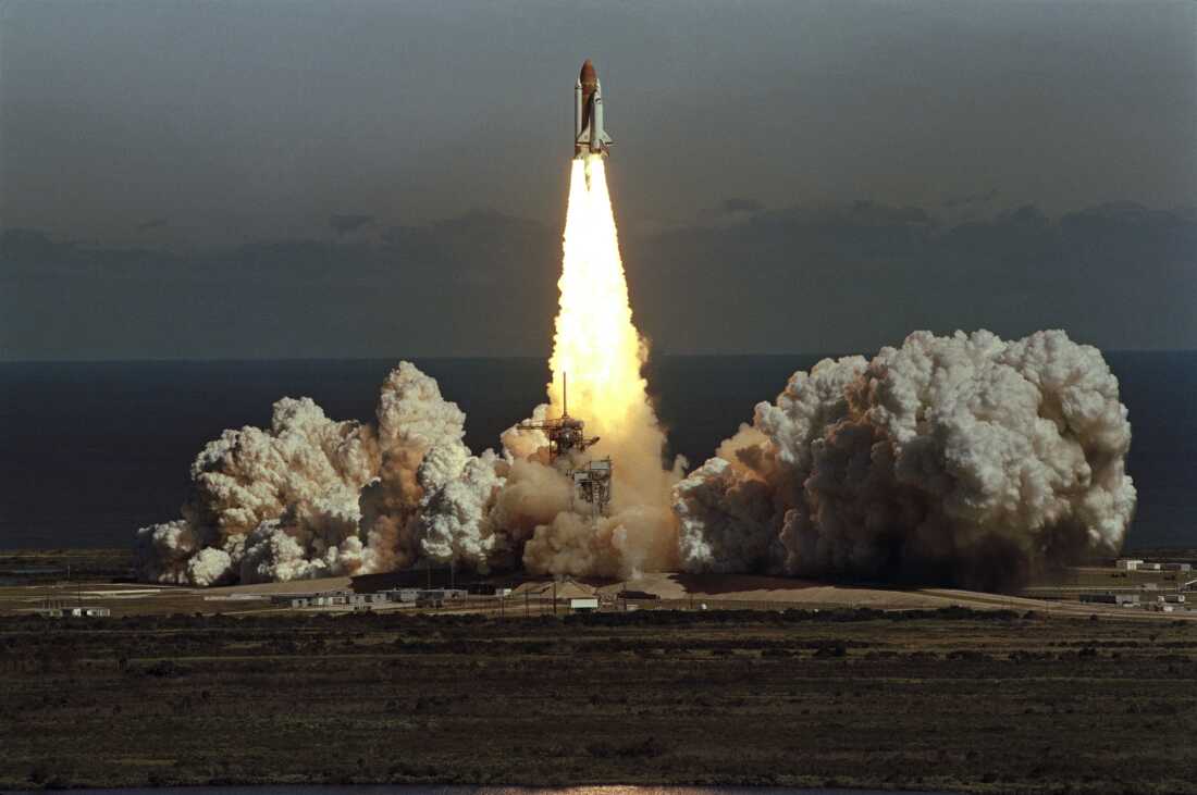 The space shuttle Challenger lifts off from Kennedy Space Center in Florida on January 28, 1986, in a cloud of smoke.