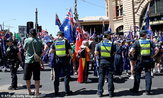 Police watch as demonstrators gather to take part in the annual "Invasion Day" protest march through the streets of Melbourne on Australia Day on January 26, 2026. (Photo by Izhar KHAN / AFP via Getty Images) 15497095