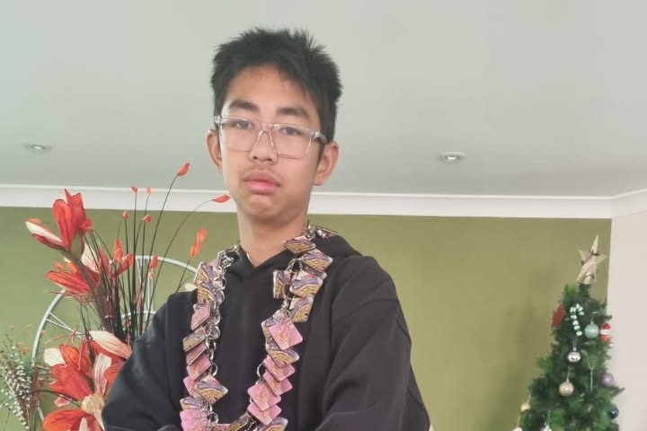 Danny stands indoors, wearing a black shirt.