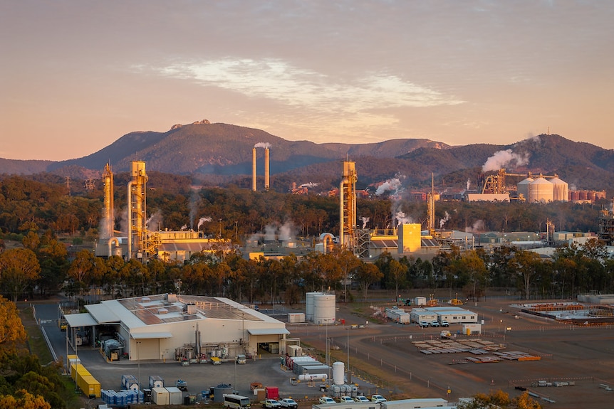 A sunset view with several different industrial buildings in view