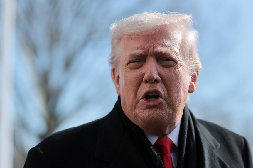 Donald Trump speaks outside.