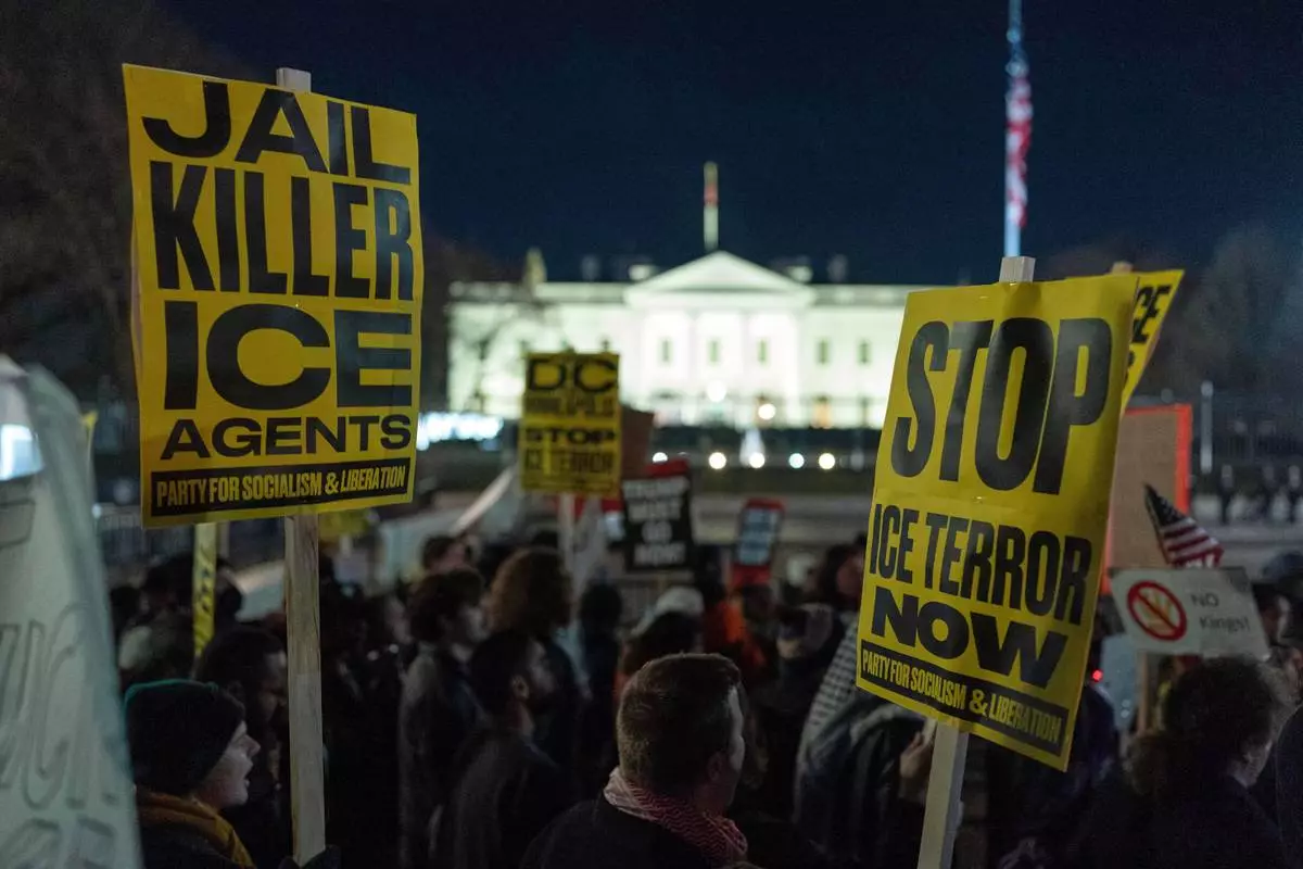 Demonstrators protest outside the White House in Washington, Thursday, Jan. 8, 2026, against the Immigration and Customs Enforcement (ICE) agent who fatally shot Renee Nicole Good in Minneapolis. (AP Photo/Jose Luis Magana)