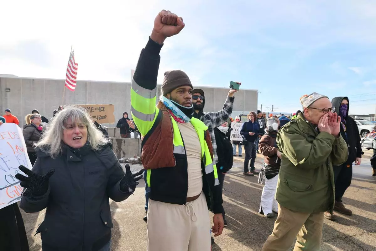 Protesters confront law enforcement outside the Bishop Henry Whipple Federal Building in Minneapolis, Friday, Jan. 9, 2026.(AP Photo/Adam Bettcher)
