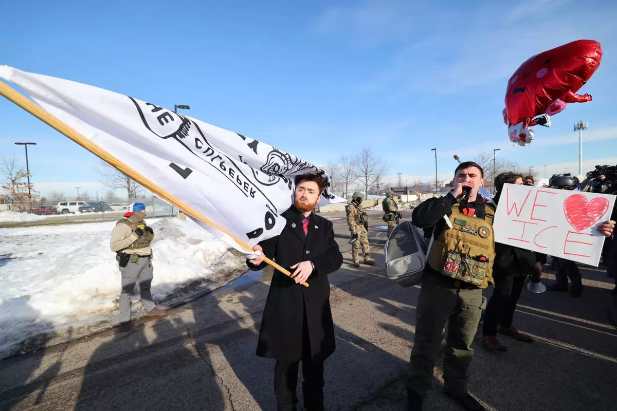 Supporters of United States Immigration and Customs Enforcement rally outside the Bishop Henry Whipple Federal Building in Minneapolis, Friday, Jan. 9, 2026. (AP Photo/Adam Bettcher)